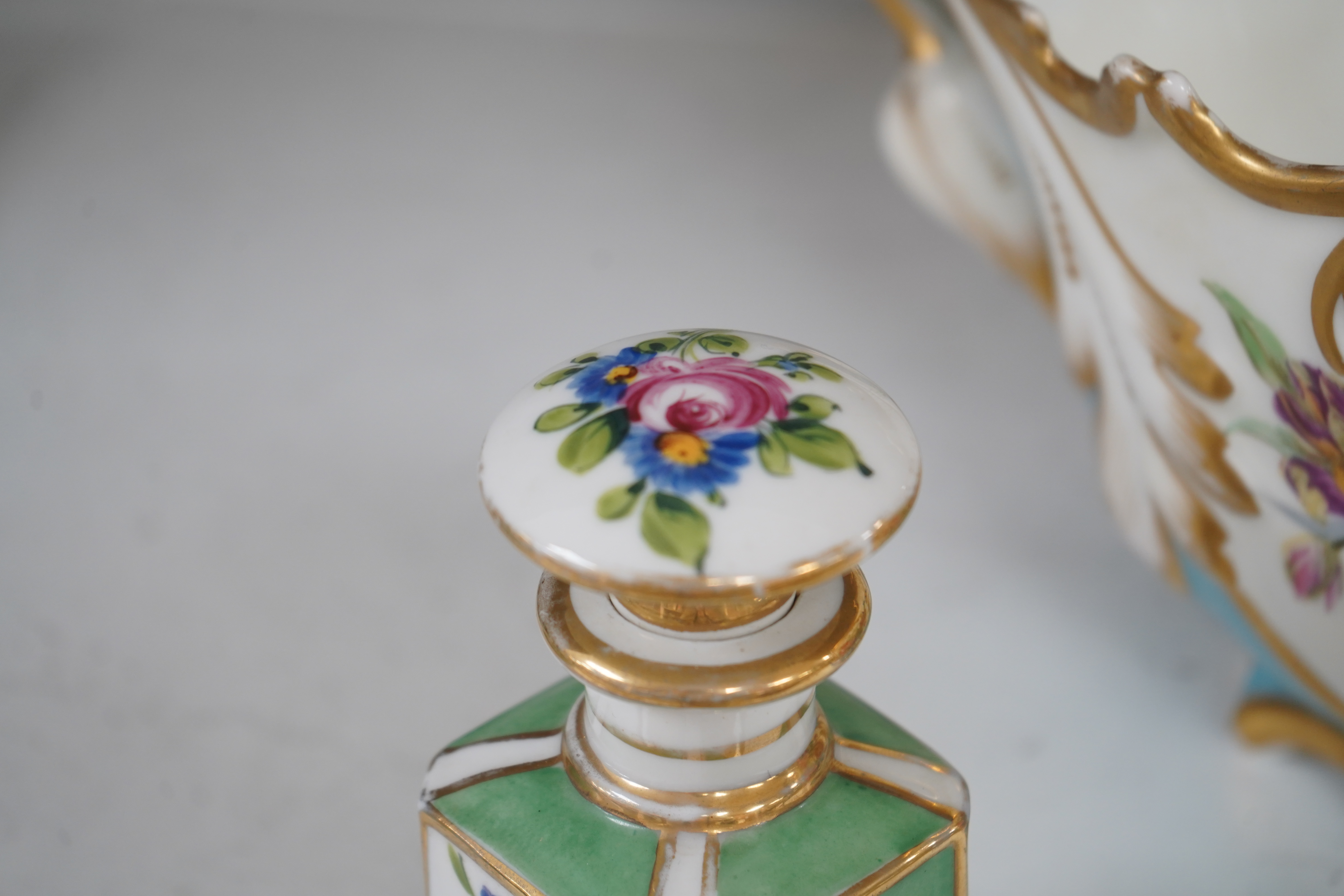 A Sevres style flower painted navette shaped jardiniere and a similar French scent bottle and stopper, late 19th century, largest 38cm wide. Condition - fair to good